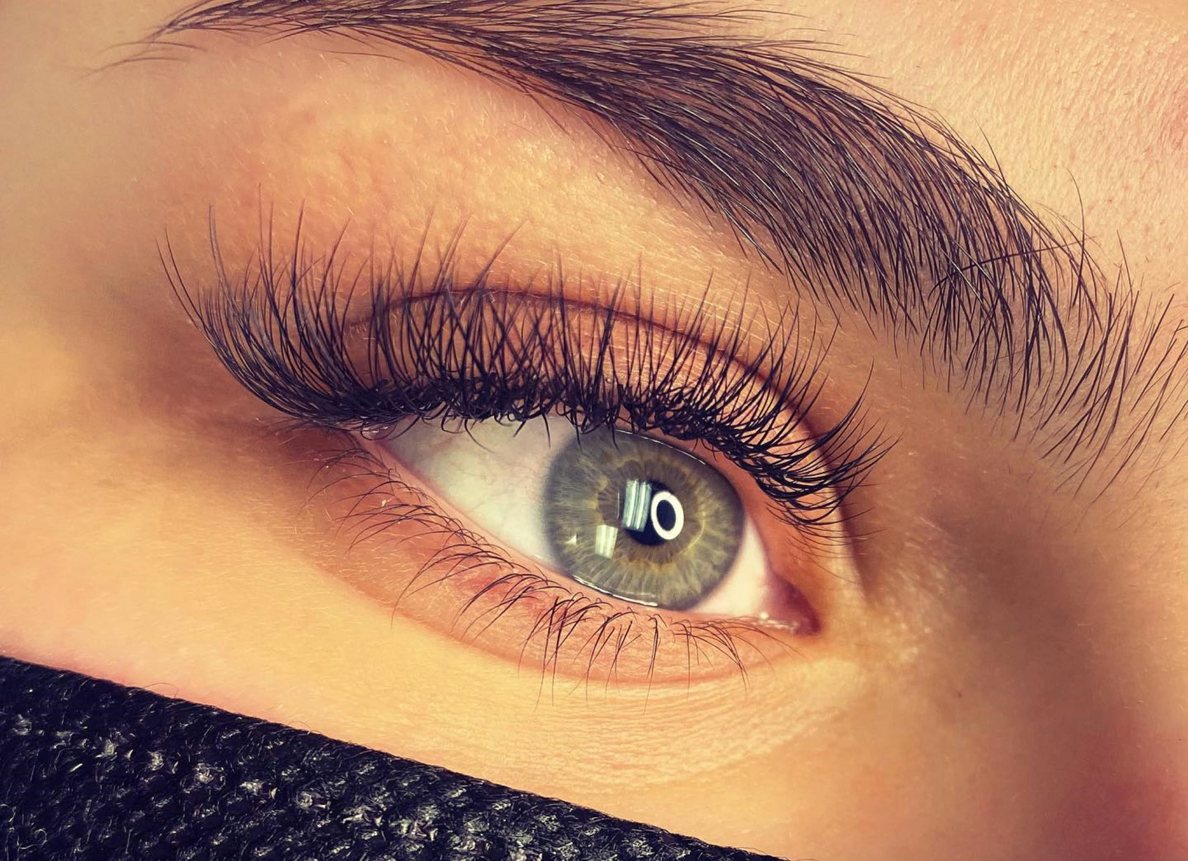 Close-up of an eye with long, darkly tinted lashes